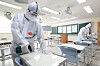 Quarantine workers disinfect a classroom for the state-administrated college entrance test in Dongtan High School in Hwaseong, Gyeonggi, on Tuesday, two days before the test will be taken by 509,821 students nationwide. [NEWS1]