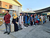 Afghans who have worked for the Korean government and their family members wait in line to board a South Korean Air Force transport plane at the Kabul airport Tuesday, local time. Some 390 evacuees are set to arrive at Incheon International Airport Thursday. [FOREIGN MINISTRY]