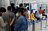 People wait in line to get tested for Covid-19 at a testing center in Mapo District, western Seoul, Friday. [YONHAP]