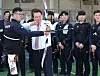 President Yoon Suk Yeol, center, fires an arrow with the help of two-time Olympic gold medalist and three-time world champion archer Kim Woo-jin at the Jincheon National Training Center in Jincheon, North Chungcheong on Tuesday. Yoon toured the training center after discussions on the 2023 Korea Sports Vision Report. [YONHAP]