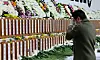 A bereaved family member of the victims of Sunday’s Jeju Air crash sheds tears at a memorial altar set up in Muan Sports Complex in Muan, South Jeolla, on Monday. [JOONGANG ILBO]