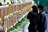 Bereaved families of the victims of Sunday’s Jeju Air crash weep at a memorial altar set up in Muan Sports omplex in Muan, South Jeolla, on Monday. [JOONGANG ILBO]