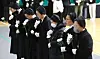 Nuns pray at a memorial altar set up in Muan Sports Complex in Muan, South Jeolla, for the victims of Sunday’s Jeju Air crash, on Monday. [JOONGANG ILBO]