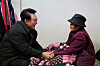 President Yoon Suk Yeol, left, speaks with a senior citizen who lives alone in a multiunit house in Jungnang District, eastern Seoul, on Thursday, to provide winter supplies amid freezing temperatures this week. [PRESIDENTIAL OFFICE]