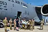 An Afghan mother who gave birth aboard a U.S. Air Force C-17 aircraft during an evacuation flight is transported to a nearby medical facility after landing at Ramstein Air Base in Germany Saturday. [U.S. AIR FORCE]