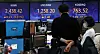A screen in Hana Bank's trading room in central Seoul shows stock and foreign exchange markets open on Tuesday. [YONHAP]