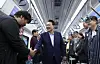 President Yoon Suk Yeol, center, greets commuters who travel in and out of the metropolitan area aboard a GTX-A train at Dongtan Station in Hwaseong, Gyeonggi, on Monday. The GTX-A train route will make an initial launch next March. [JOINT PRESS CORPS]