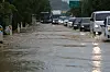Vehicles move slowly on national route 1 in Munsan-eup, Paju, Gyeonggi, as the road is submerged with water. [YONHAP]