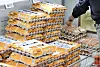 A shopper picks a pack of eggs at a supermarket in Seoul on March 24. [YONHAP]