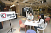 Workers talk in the new K bank office in Euljiro, central Seoul. The new office has been designed with top notch digital equipment to improve working environment, the internet-only bank said Tuesday. In the lounge, a coffee-making robot has been installed. [KBANK]