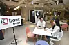 Workers talk in the new K bank office in Euljiro, central Seoul. The new office has been designed with top notch digital equipment to improve working environment, the internet-only bank said Tuesday. In the lounge, a coffee-making robot has been installed. [KBANK]