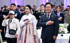 President Lee Jae Myung, right, and his wife, Kim Hea Kyung, left, pay respect to the Korean flag during a luncheon meeting for people of national merit, war veterans and their family members at the former presidential office, Cheong Wa Dae, in Seoul on June 27, 2025. [JOINT PRESS CORPS]