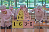 Cafeteria workers at Jigok Elementary School in Pohang, North Gyeongsang, wipe tables and plexiglass dividers Tuesday, a day before first and second graders return to school for the first time since the Covid-19 pandemic. [NEWS1]