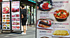 A menu banner of a restaurant is installed in a street in Myeong-dong, central Seoul, in May. [YONHAP]
