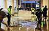 Workers clean up the KTX Gwangmyeong Station Wednesday afternoon as the station was flooded after heavy rain. [YONHAP]