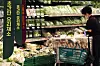 A visitor to a supermarket in downtown Seoul looks at the options in the vegetable section on Thursday. The prices of popular vegetables during the summer season, such as cabbage, lettuce and young radish, more than doubled on year due to unfavorable factors including the prolonged wet season. On Tuesday, the price of lettuce was 9,317 won ($7.86) per bundle, a 150 percent on-year increase. [YONHAP]