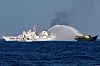 Chinese Coast Guard vessels fire water cannons towards a Philippine resupply vessel Unaizah on its way to a resupply mission at Second Thomas Shoal in the South China Sea, March 5, 2024. [REUTERS/YONHAP]