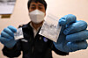 An official holds up bags containing drugs during an inter-department meeting on drugs held at the Seoul Regional Customs office in Gangnam District, southern Seoul, on Thursday. The Korea Customs Service announced on the same day that the quantity of drugs confiscated by the governmental organization reached an all-time high this year. [NEWS1]