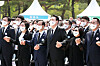 President Yoon Suk-yeol, center, sings 'March for the Beloved' in a ceremony marking the 42nd anniversary of the May 18 Democratization Movement at the national cemetery in Gwangju Wednesday. [YONHAP]