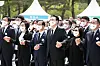 President Yoon Suk-yeol, center, sings 'March for the Beloved' in a ceremony marking the 42nd anniversary of the May 18 Democratization Movement at the national cemetery in Gwangju Wednesday. [YONHAP]