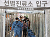 People wait in a long line to get tested for Covid-19 at a testing center in Gwanak District, southern Seoul, on Wednesday morning, when the country's daily new infections surged to a record 2,223. [YONHAP]