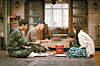 Ri Jung-hyuk (played by Hyun Bin), second from left, grills some meat on charcoals at the request of Yoon Se-ri (played by Son Ye-jin), far right, in the drama series ’Crash Landing on You,“ set in a small North Korean village.Ri Jung-hyuk (played by Hyun Bin), second from left, grills some meat on charcoals at the request of Yoon Se-ri (played by Son Ye-jin), far right, in the drama series ’Crash Landing on You,“ set in a small North Korean village. [TVN]