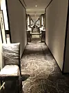 Chairs act as some kind of barricade outside rooms in a quarantine hotel. [ANTHONY SPAETH]