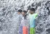 Children beat the heat by standing in a fountain at a park in Suwon, Gyeonggi, as the heatwave continued to strike the country. [YONHAP]