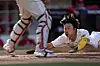 San Diego Padres' Kim Ha-seong scores past Philadelphia Phillies catcher J.T. Realmuto on a hit by Austin Nola during the fifth inning of Game 2 of the National League Championship Series between the Padres and the Philadelphia Phillies at Petco Park in San Diego on Wednesday. The Padres won the game 8-5 to tie the series at one game apiece. [AP/YONHAP]
