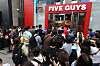Crowds of people queue to buy burgers in front of the country's first store of U.S. made-to-order burger chain Five Guys in Gangnam District, southern Seoul, on its opening day on Monday. [YONHAP]