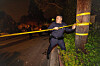 A police officer puts up crime scene tape in the Brentwood Park neighborhood, where the bodies of two elderly people were found at the home of Hollywood director Rob Reiner in Los Angeles on Dec. 14. [REUTERS/YONHAP]