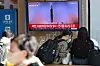 Passengers at Seoul Station sit in front of a morning news broadcast covering the latest missile launch by North Korea. [YONHAP]