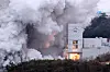 Space launch vehicle Nuri’s first-stage engines undergo a combustion test at the Naro Space Center in Goheung, South Jeolla, Thursday. According to the Ministry of Science and ICT, the Korea Aerospace Research Institute, which leads the project’s development, ran the 100-second combustion test for first-stage engines, consisting of four 75-ton liquid engines, to check their durability before the locally built launch vehicle’s launch set for October. This was the second round of tests. The institute plans to conduct a final 130-second run next month that will wrap up development of the first stage of the launch vehicle. [YONHAP]