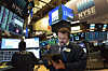 A stock trader works at the New York Stock Exchange on Friday, March 2020. [AP]