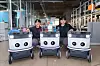 Neubility Vice President Kang Kee-hyuk, left, and Neubility CEO Lee Sang-min pose with three Neubie robots at the Neubility office in Seongdong District, eastern Seoul [CHO YONG-JUN]