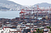 Containers are piled up at a port in Busan on Friday. [YONHAP]