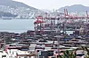 Containers are piled up at a port in Busan on Friday. [YONHAP]