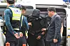 Police officials escort a man who opened an emergency exit door mid-flight on an Asiana Airlines plane to his warrant hearing at the Daegu District Court on Sunday. [NEWS1]
