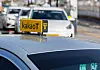 A Kakao T Blue taxi, booked with a call, waits for its passenger at a taxi lane in Seoul Station on Tuesday afternoon. [YONHAP]