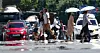 People cross a street in Jung District, Daegu, where a heat wave warning has been in effect since July 22, on Wednesday. [YONHAP]