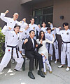 Celebrity couple Woo Hye-rim and Shin Min-cheol, center, take a wedding photograph with members of Shin's extreme taekwondo group Mirme. [RRR ENTERTAINMENT]