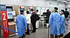 Health officials direct travelers from China registering for Covid-19 testing at Incheon International Airport on Tuesday. [YONHAP]