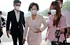 Justice Minister Choo Mi-ae, center, is hounded by reporters as she goes to work at the ministry on Thursday. [YONHAP]