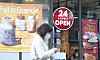A sign saying '24 Hours Always Open' hangs in front of a cafe in Gangnam District, southern Seoul, on Monday. The government announced a draft for the 'With Corona' scheme that will allow restaurants and bars to stay open 24 hours a day. [YONHAP]