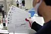 An employee categorizes tax bills at a post office in Gangnam District, southern Seoul, on Nov. 24. [YONHAP]