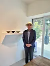 Ceramic artist Kwon Dae-sup stands by his bowls at Park Ryu Sook Gallery in Seoul on Wednesday.[MOON SO-YOUNG]