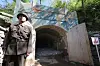A North Korean soldier stands guard outside the No. 2 tunnel at the Punggye-ri underground nuclear testing site in North Pyongan Province in May 2018. [JOINT PRESS CORPS]