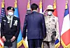 Tefera Negussie Moru, right, an Ethiopian veteran of the 1950-53 Korean War, salutes President Yoon Suk-yeol, center, after Yoon presented him with the Ambassador for Peace Medal at a ceremony with over a dozen veterans of the war in Shilla Hotel in Seoul on Friday. [YONHAP]