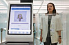 An Incheon International Airport employee demonstrates how to register facial recognition information at the airport on Monday. The Smart Pass system, which enables tourists to undergo departure procedures more easily using only this information, is scheduled to be introduced at the end of the month, while the registration of faces and passport information to use this service has been available on the 'ICN SmartPass' mobile application. [YONHAP]