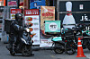 A delivery rider parks the motorcycle in front of a restaurant in Seoul on Tuesday [YONHAP]
